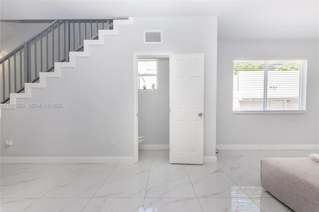 a view of an entryway with wooden floor