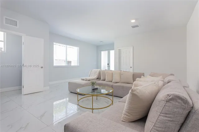 a living room with furniture a window and a table