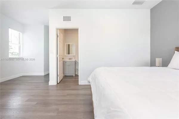 a bedroom with a bed and a night stand