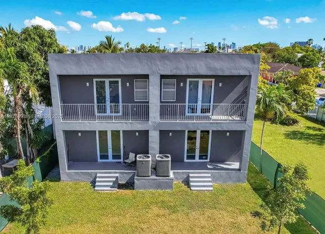 a view of a house with swimming pool and sitting area