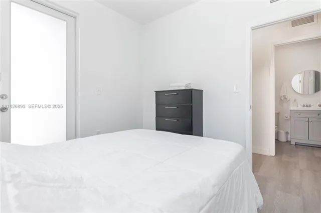 a bedroom with a bed and a view of bathroom