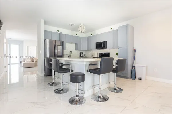 a kitchen with granite countertop sink cabinets and window