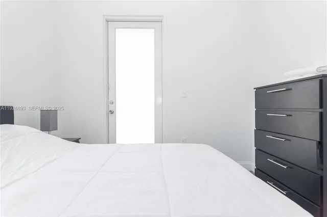 a bedroom with a bed and a mirror