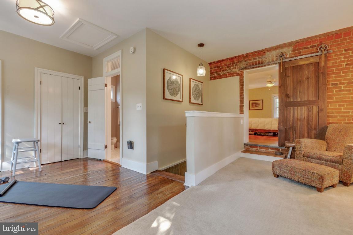 16191 Hamilton Station Road Waterford, VA 20197 - Photo 39 of 94 Sliding wood barn door on original brick