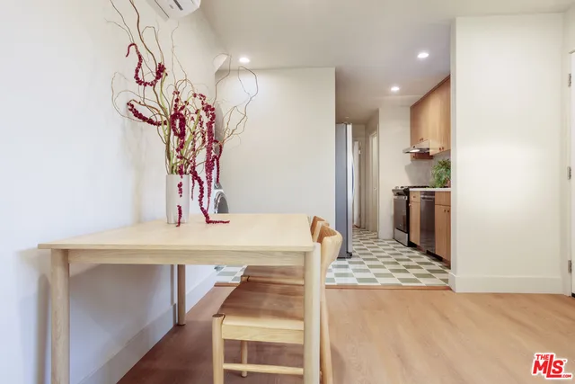 a view of a kitchen with a sink and refrigerator