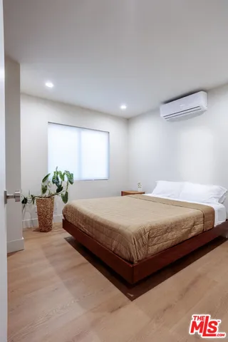 a spacious bedroom with a bed and a couch