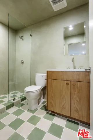 a bathroom with a toilet and a shower