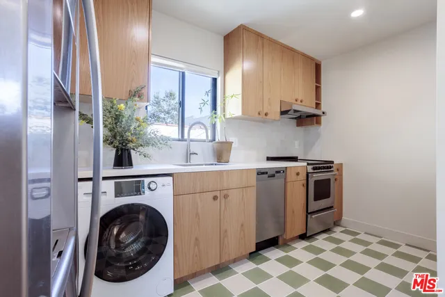 a utility room with sink dryer and washer
