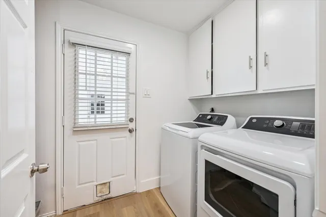a view of washer and dryer with kitchen in the background