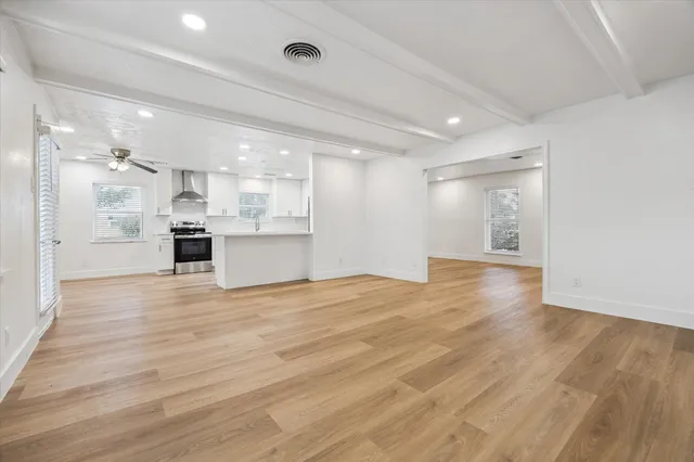 a view of a kitchen with a sink and a refrigerator
