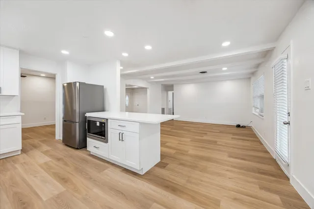 a kitchen with stainless steel appliances a refrigerator and a stove top oven
