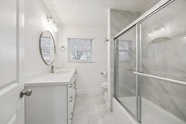 a bathroom with double vanity and a shower