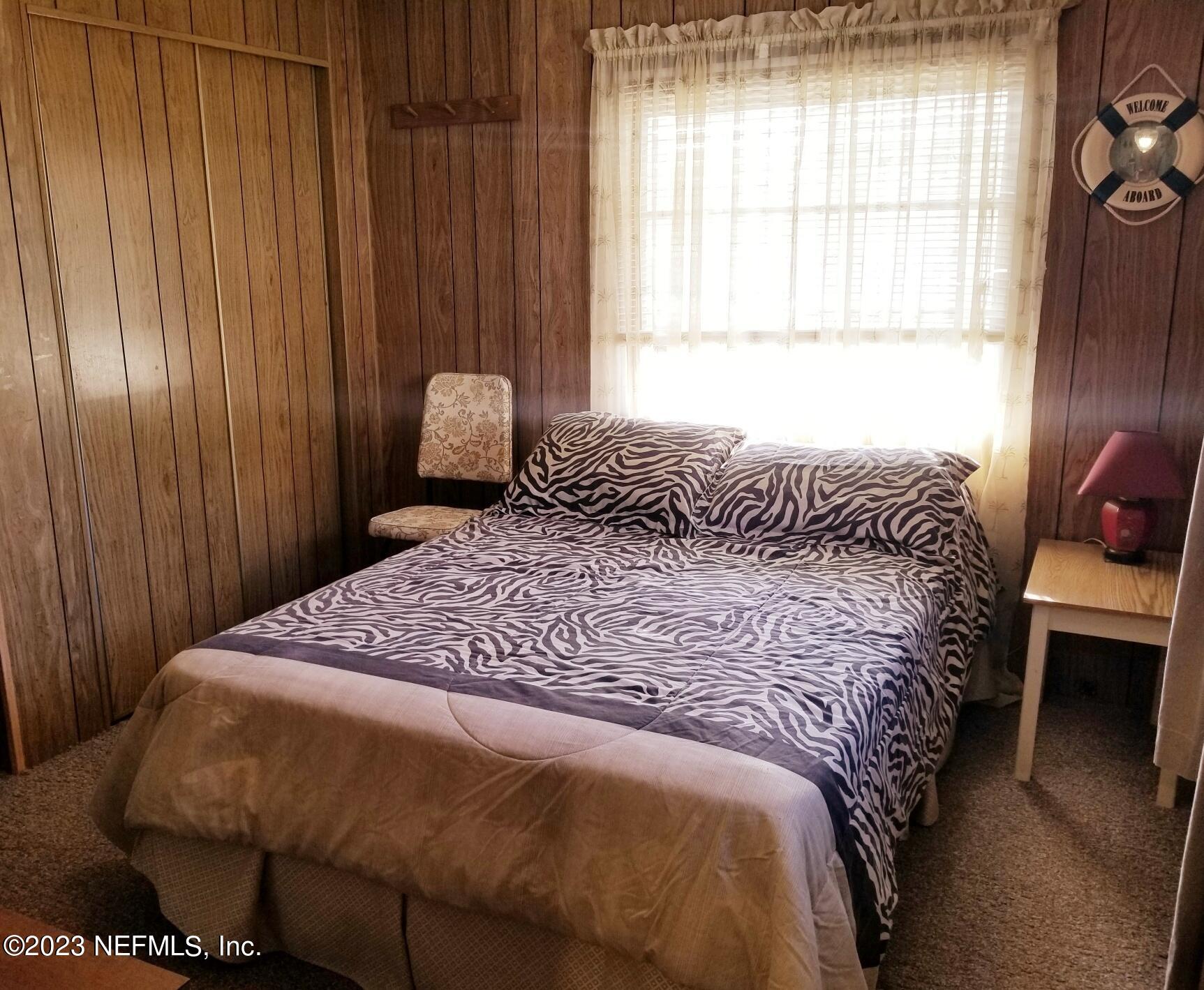 116 Douglas Street Crescent City, FL 32112 - Photo 12 of 26 a bedroom with a bed and a window