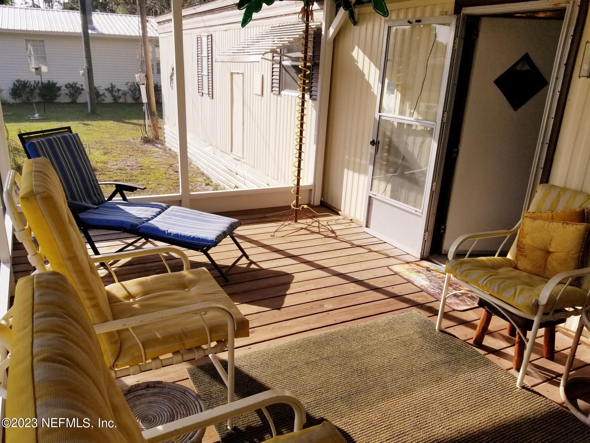 116 Douglas Street Crescent City, FL 32112 - Photo 4 of 26 a bedroom with a bed and glass windows