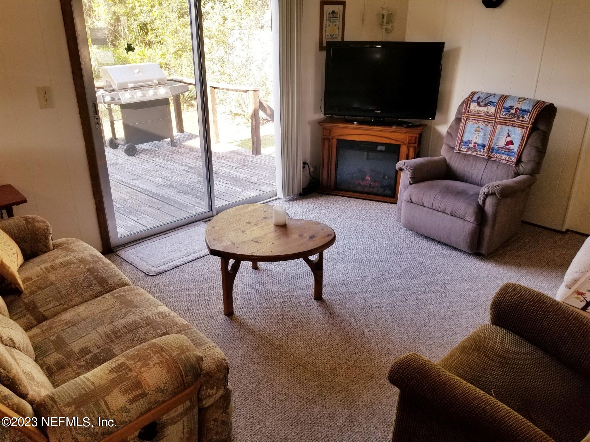 116 Douglas Street Crescent City, FL 32112 - Photo 5 of 26 a living room with furniture and a flat screen tv