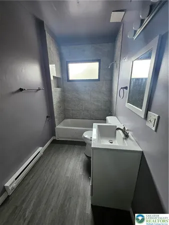 a bathroom with a sink toilet and mirror