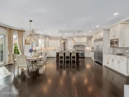 a kitchen with lots of counter space dining table and chairs