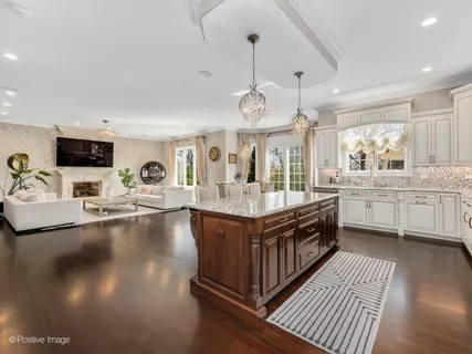 a large kitchen with stainless steel appliances granite countertop a lot of counter space and a sink