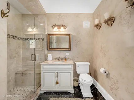 a bathroom with a toilet sink and shower