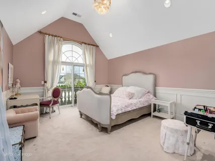 a spacious bedroom with a bed and large windows