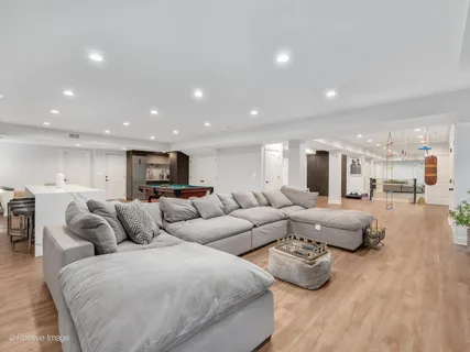 a living room with furniture and view of kitchen