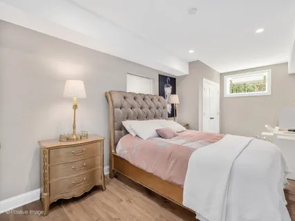 a bedroom with a bed and a night stand