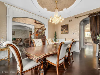 a view of a dining room with furniture wooden floor and chandelier