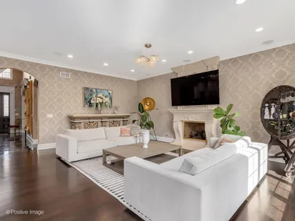 a living room with fireplace furniture and a flat screen tv