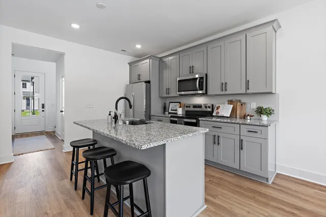 a kitchen with sink a stove and cabinets