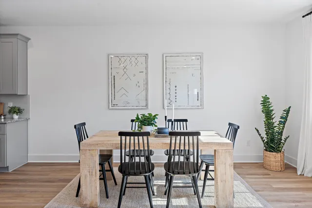 a view of a dining room with furniture and wooden floor