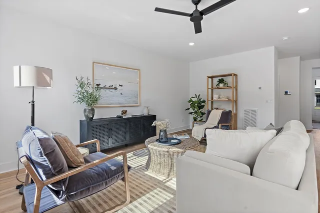a living room with furniture and a potted plant