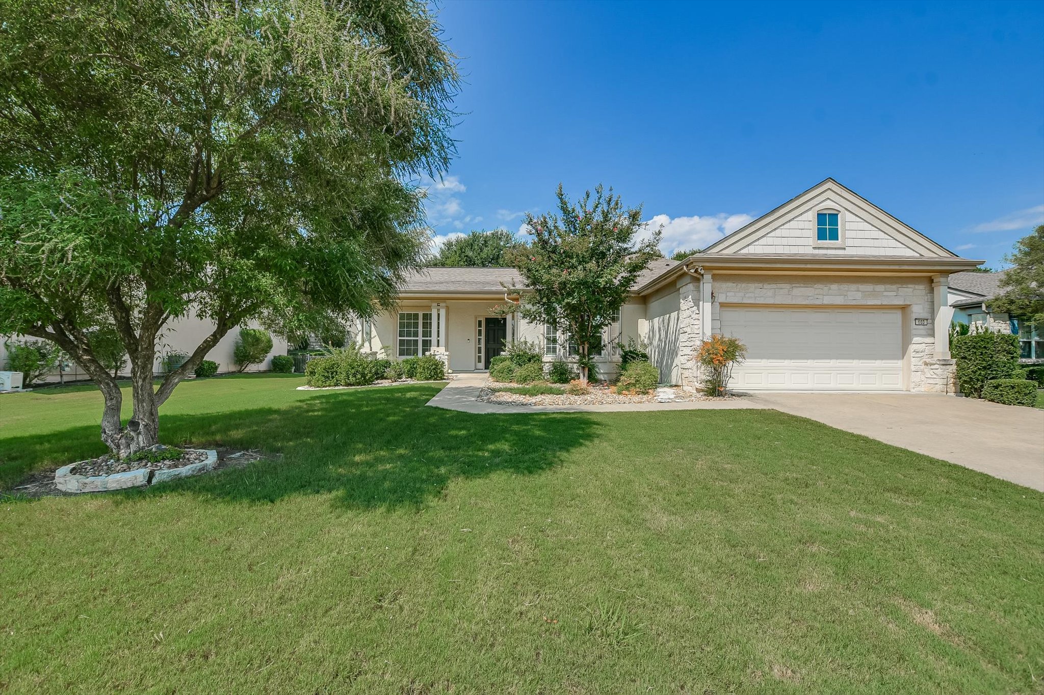 603 Rio Grande Loop Georgetown, TX 78633 - Photo 2 of 27 Ranch-style home with a porch, an attached garage, concrete driveway, a front yard, and stone siding