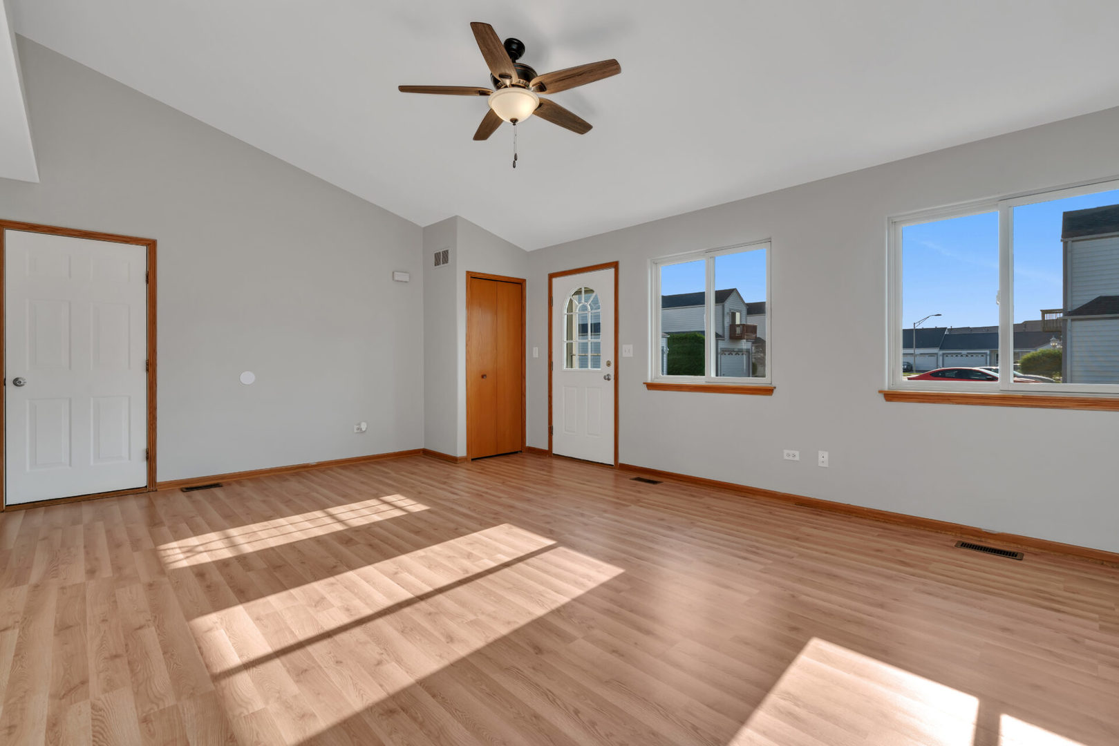1747 Waters Edge Drive Minooka, IL 60447 - Photo 3 of 11 a view of an empty room with window and wooden floor