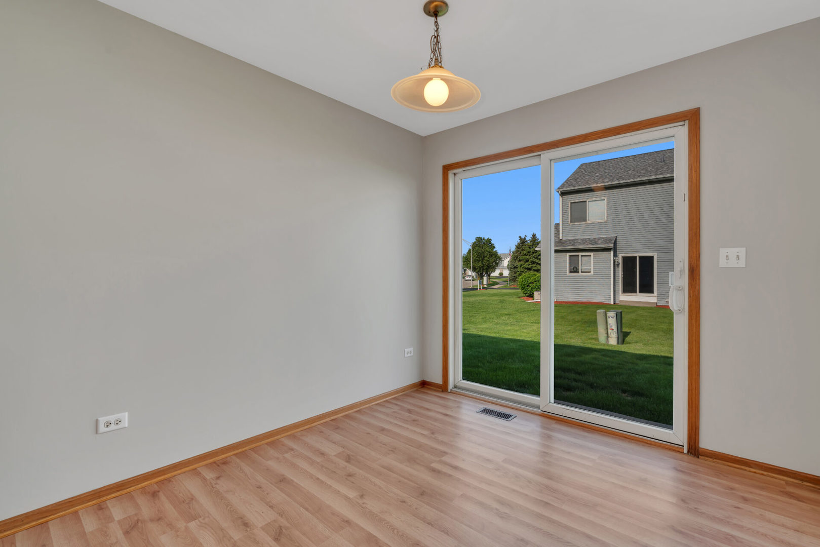 1747 Waters Edge Drive Minooka, IL 60447 - Photo 6 of 11 wooden floor in an empty room with a window