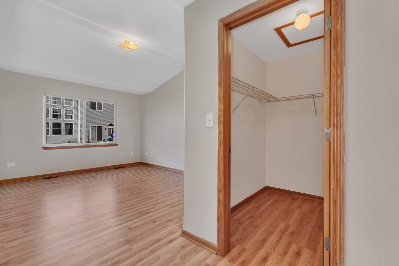 1747 Waters Edge Drive Minooka, IL 60447 - Photo 8 of 11 a view of an empty room with wooden floor and a window
