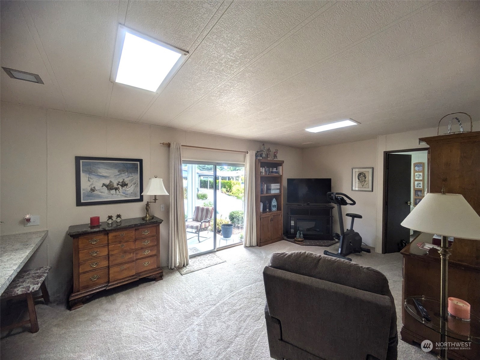 201 Union Avenue Southeast, Unit 104 Renton, WA 98059 - Photo 15 of 36 a living room with furniture and a flat screen tv