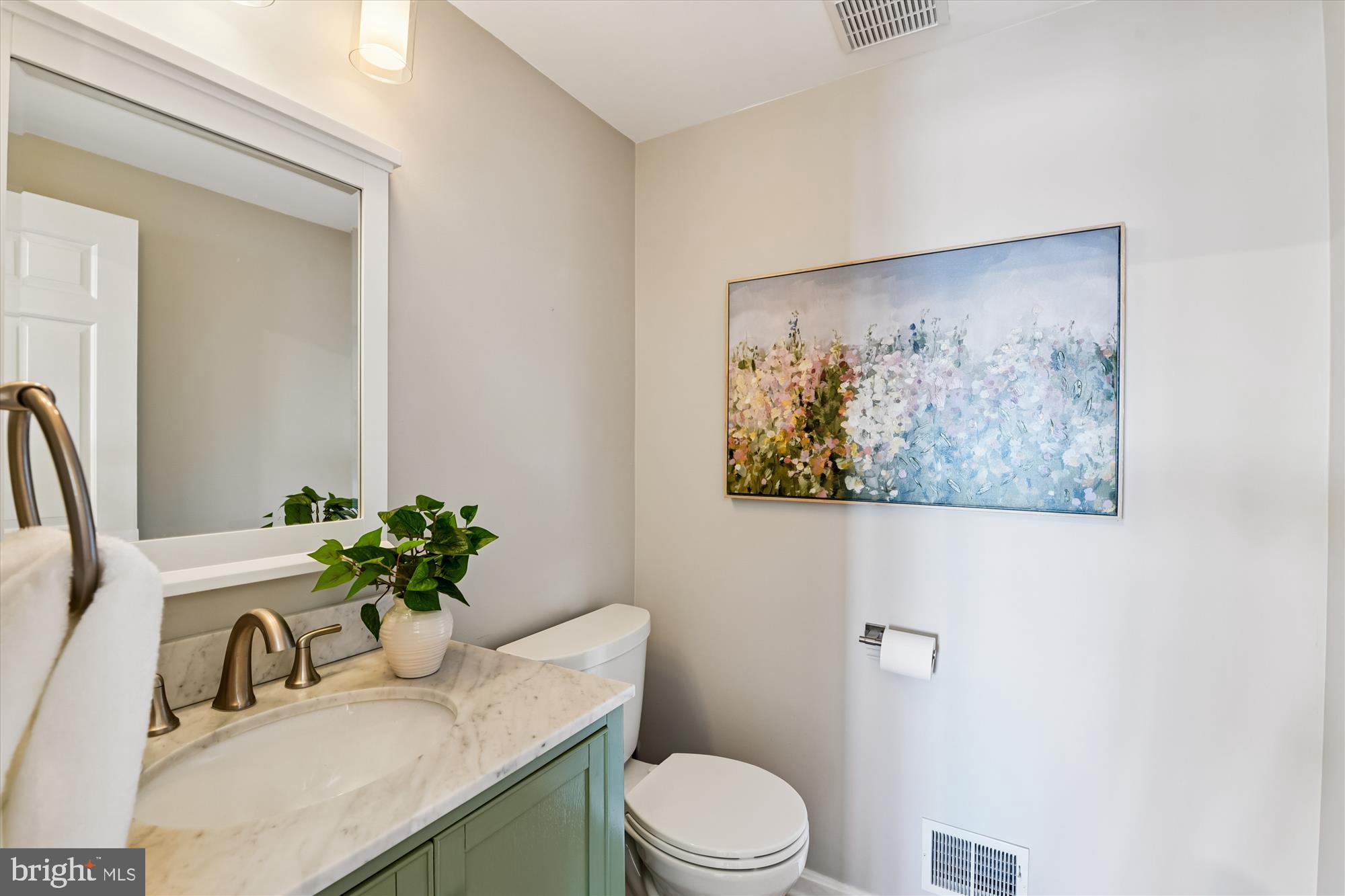 1006 West Joppa Road Towson, MD 21204 - Photo 16 of 47 a bathroom with a toilet a sink and mirror