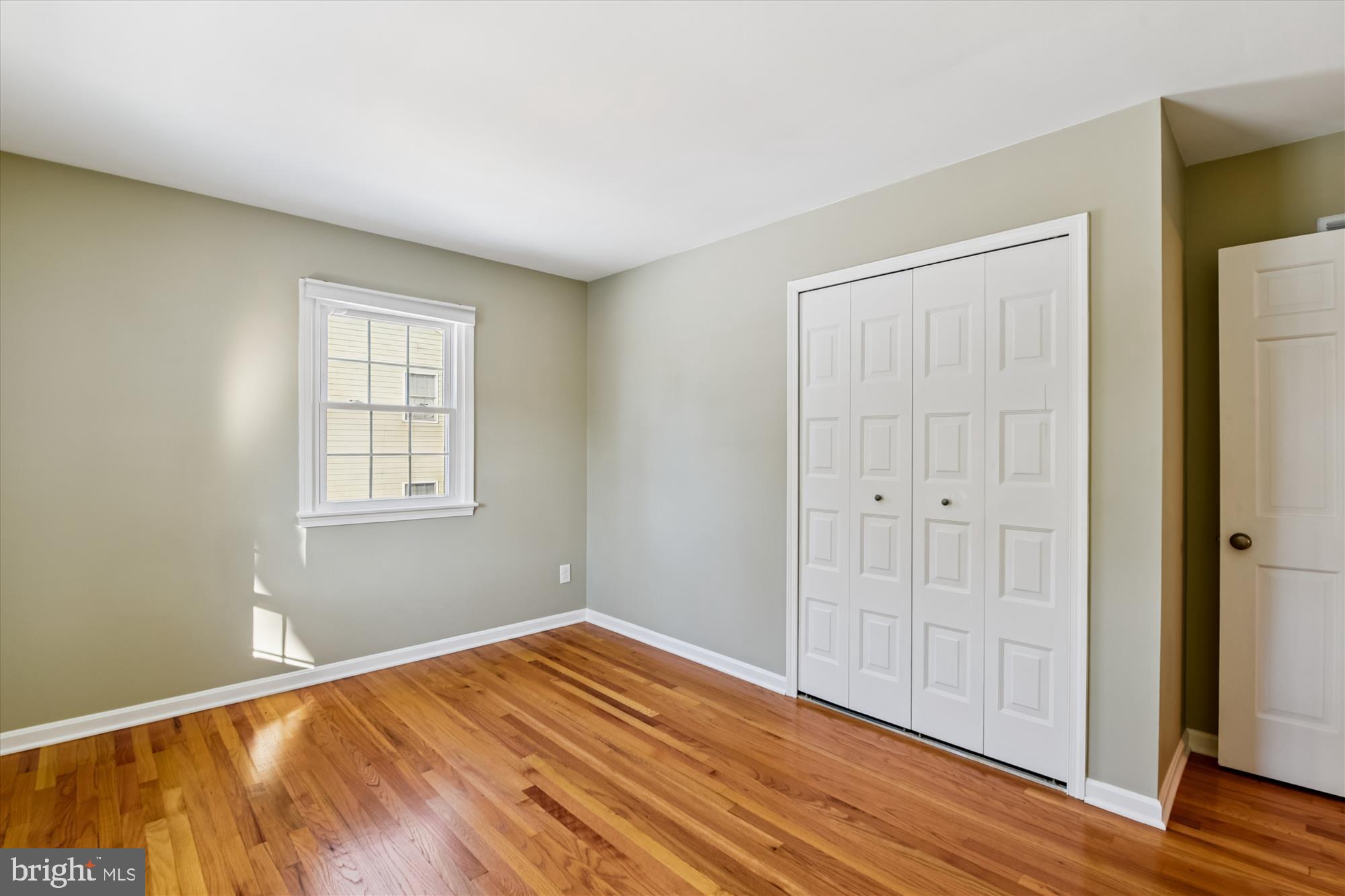 1006 West Joppa Road Towson, MD 21204 - Photo 28 of 47 an empty room with wooden floor closet and windows