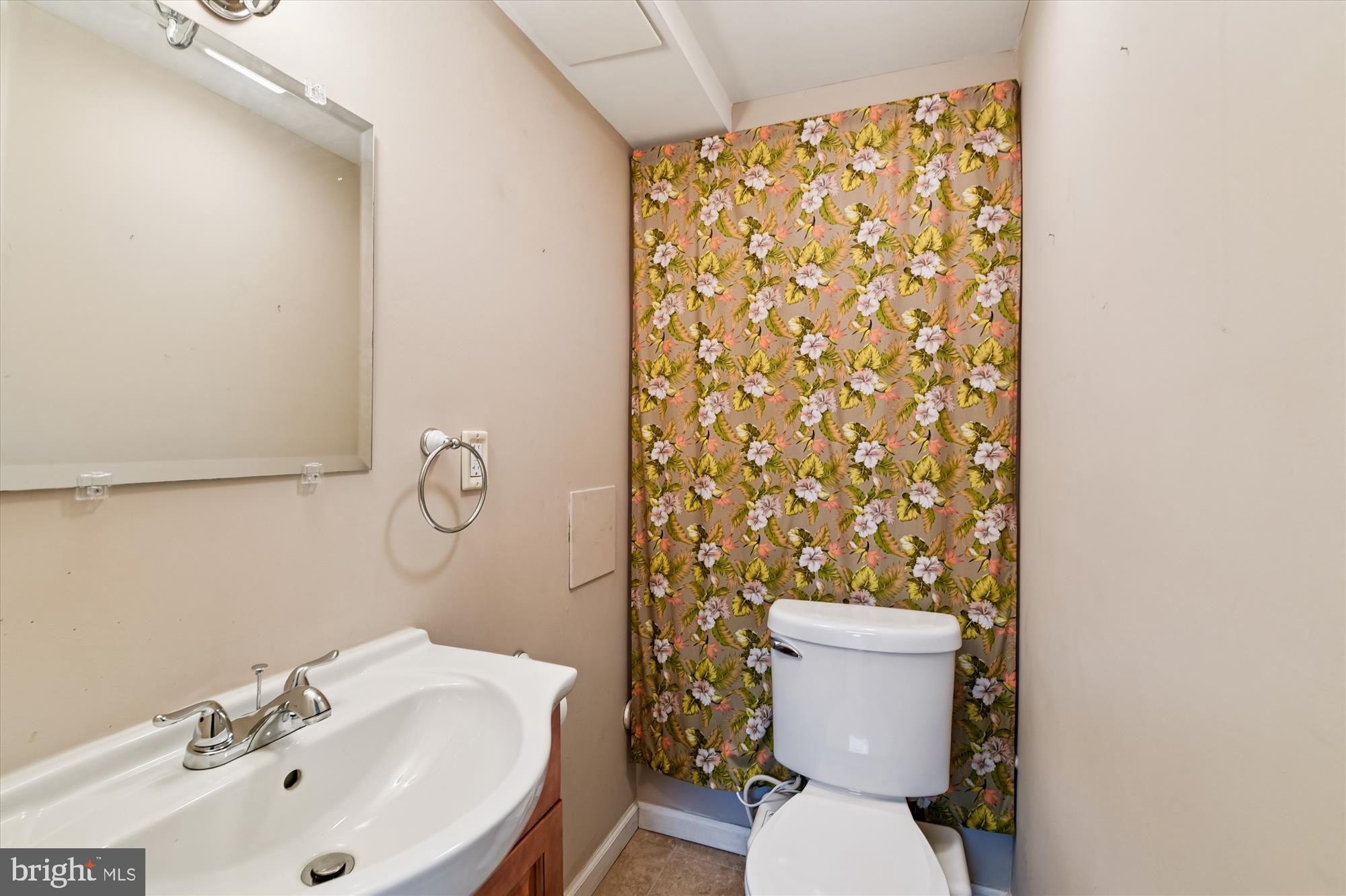 1006 West Joppa Road Towson, MD 21204 - Photo 35 of 47 a bathroom with a sink mirror and toilet