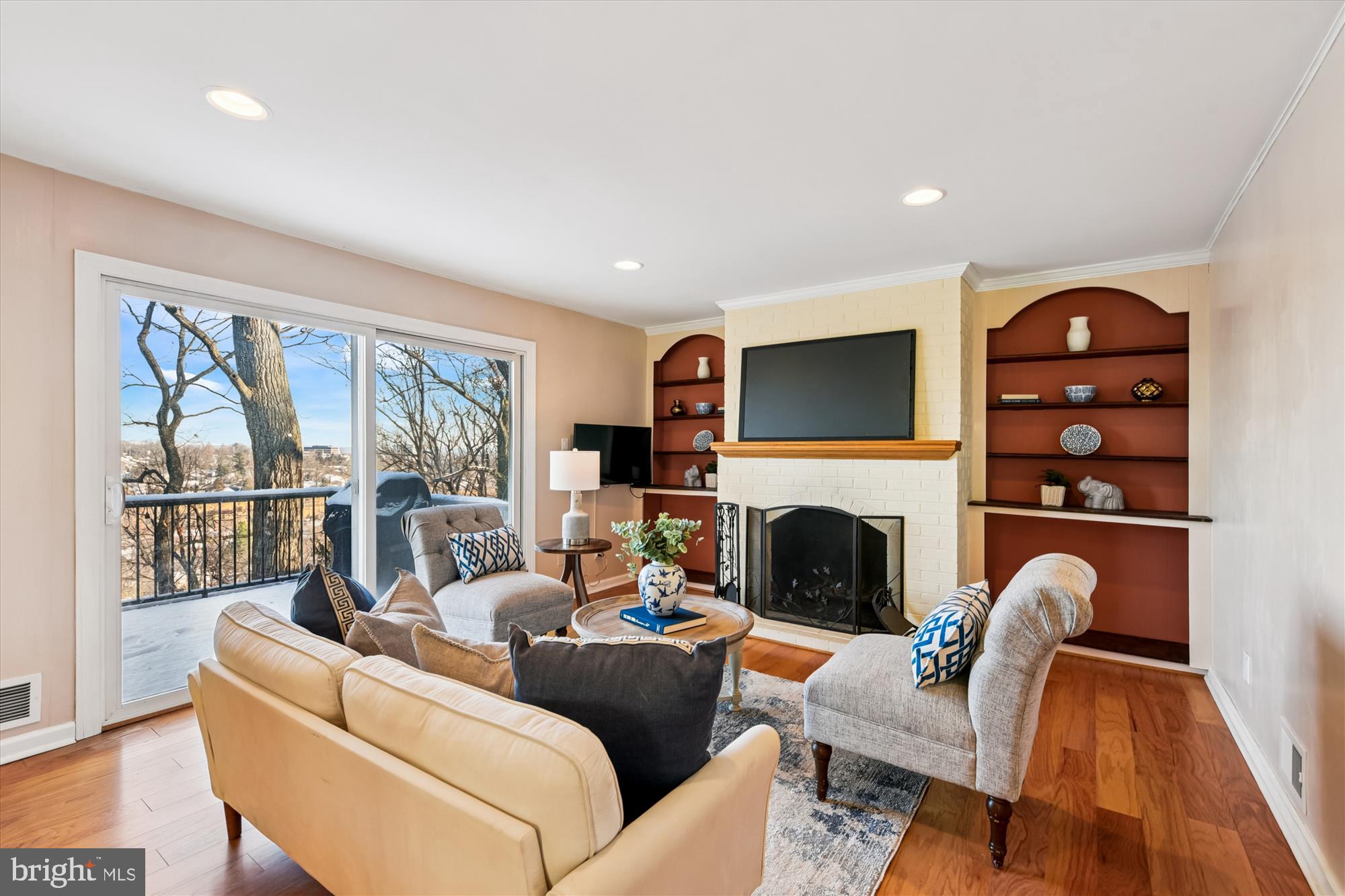 1006 West Joppa Road Towson, MD 21204 - Photo 7 of 47 a living room with furniture a fireplace and a floor to ceiling window