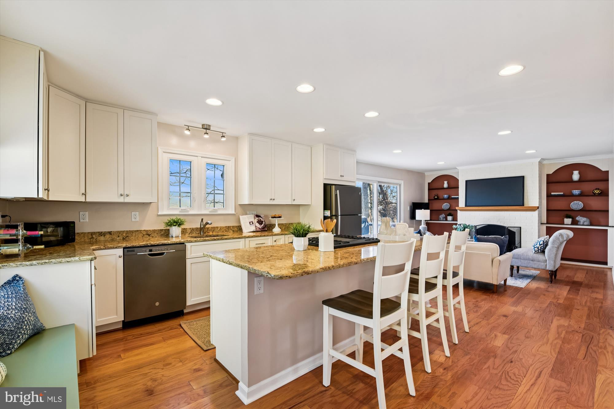1006 West Joppa Road Towson, MD 21204 - Photo 10 of 47 a kitchen with stainless steel appliances kitchen island granite countertop a stove top oven a sink a dining table and chairs