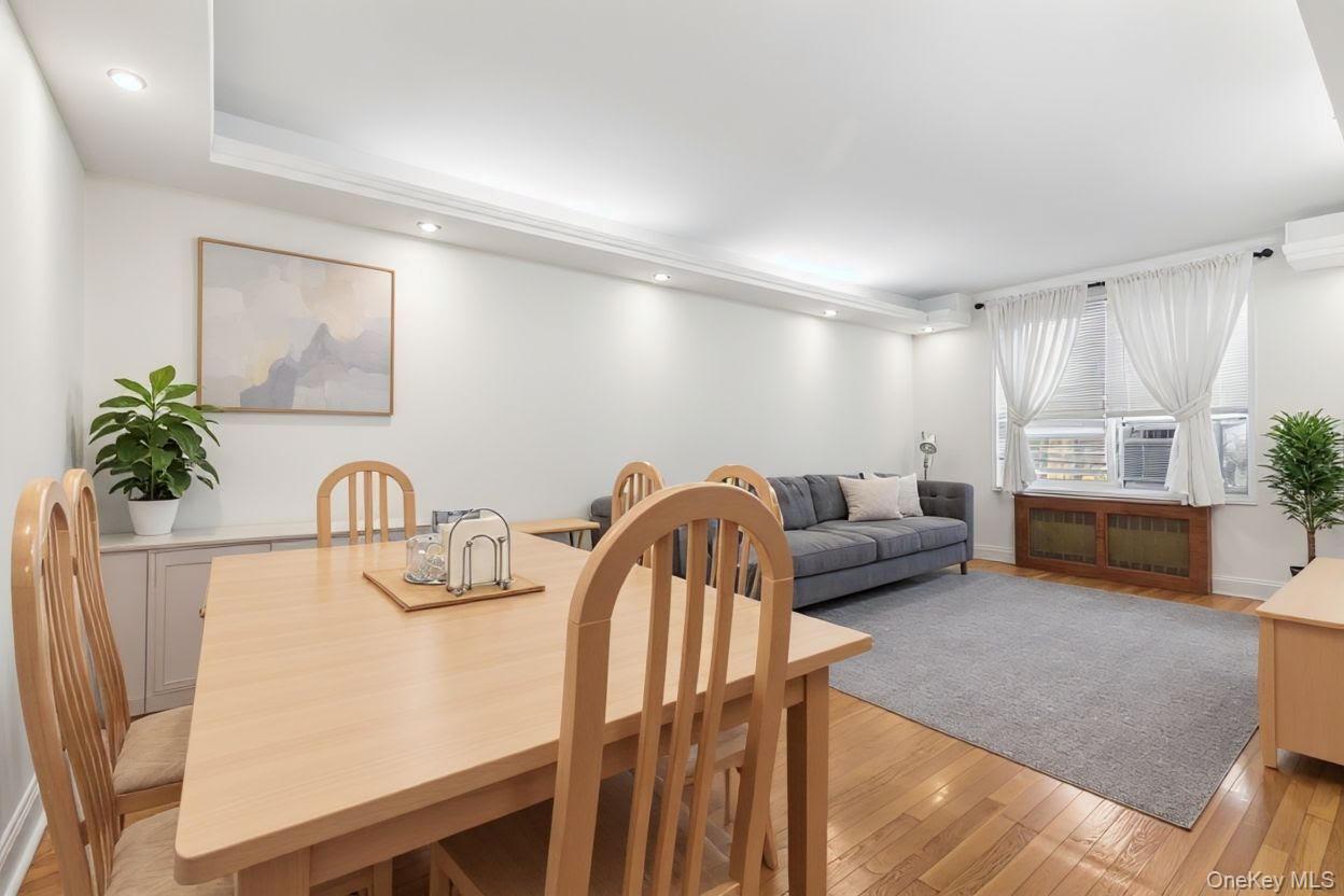 64-11 99th Street, Unit 3O4 Queens, NY 11374 - Photo 11 of 23 Dining area with light wood-type flooring, recessed lighting, a wall unit AC, and radiator