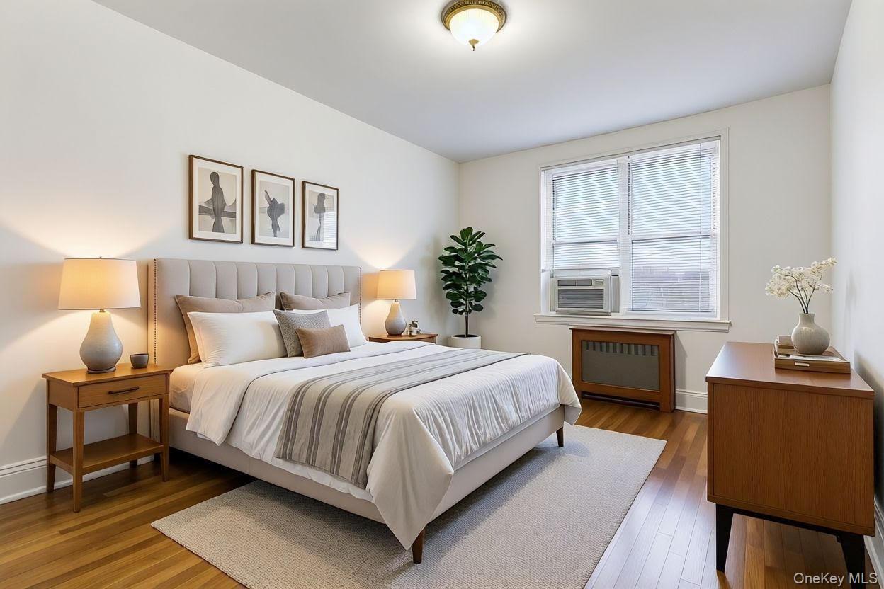 64-11 99th Street, Unit 3O4 Queens, NY 11374 - Photo 20 of 23 Bedroom featuring wood-type flooring, radiator heating unit, and cooling unit