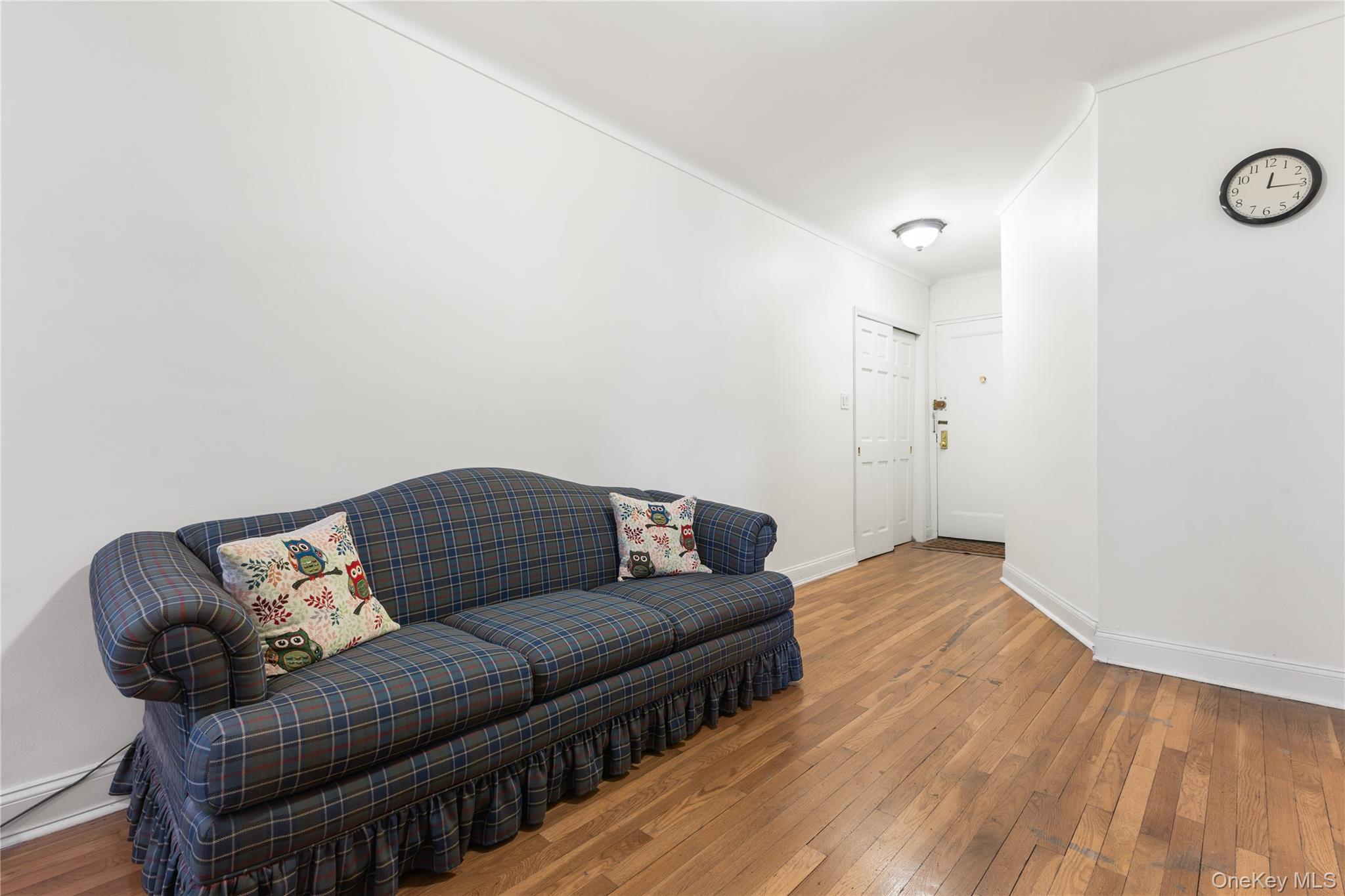 64-11 99th Street, Unit 3O4 Queens, NY 11374 - Photo 4 of 23 Living area featuring wood-type flooring and baseboards
