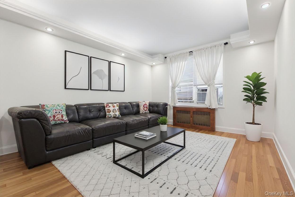 64-11 99th Street, Unit 3O4 Queens, NY 11374 - Photo 7 of 23 Living area featuring recessed lighting, light wood-type flooring, radiator heating unit, and cooling unit