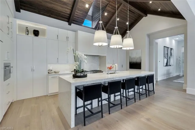 a kitchen with stainless steel appliances kitchen island a chandelier