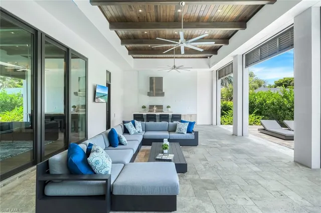 a living room with furniture and a floor to ceiling window