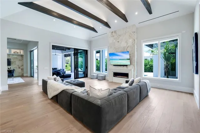 a living room with fireplace furniture and a large window