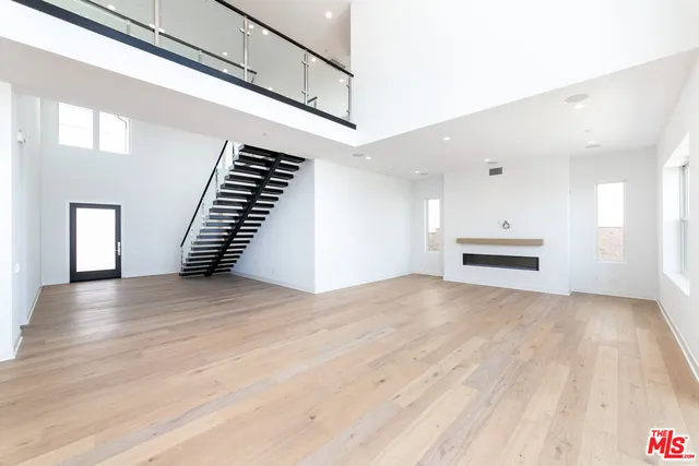 a view of a kitchen with large windows