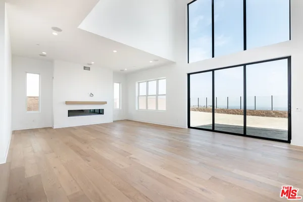a living room with furniture and a book shelf